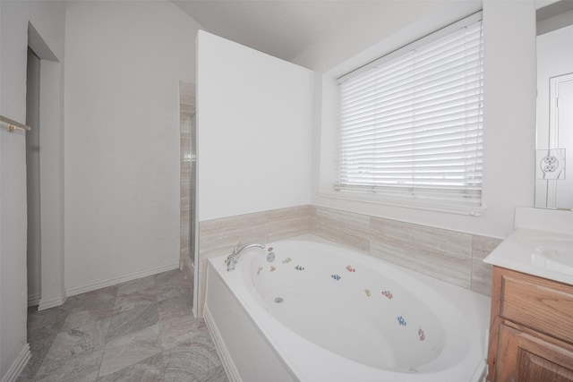 bathroom featuring separate shower and tub and vanity