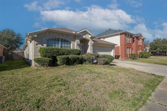 ranch-style home with a front yard, central AC, and a garage