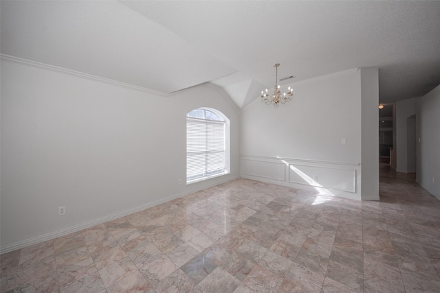 empty room with vaulted ceiling, crown molding, and a chandelier