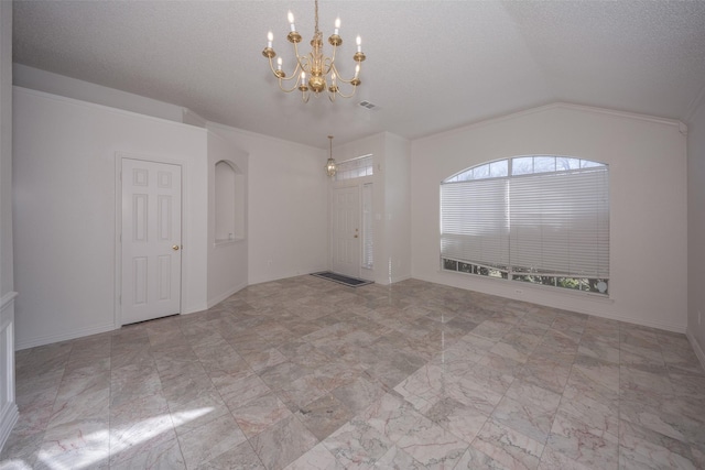 empty room featuring ornamental molding, lofted ceiling, a textured ceiling, and a chandelier