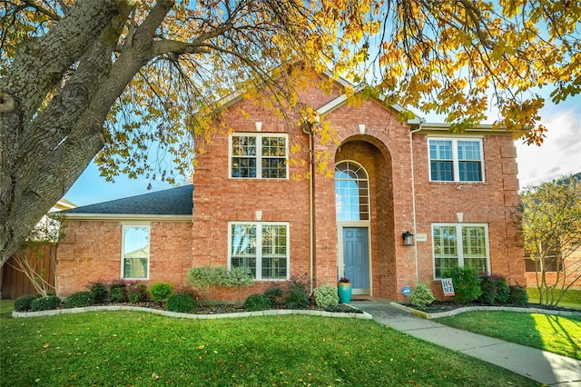 colonial house with a front lawn and central air condition unit