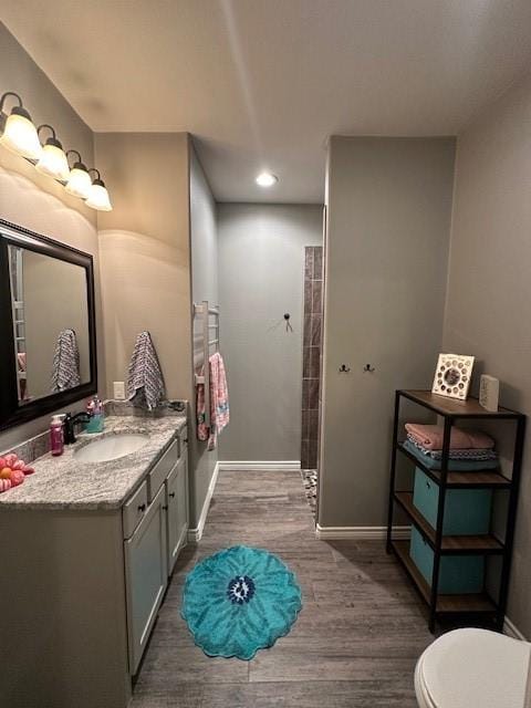 bathroom featuring vanity, hardwood / wood-style floors, and toilet