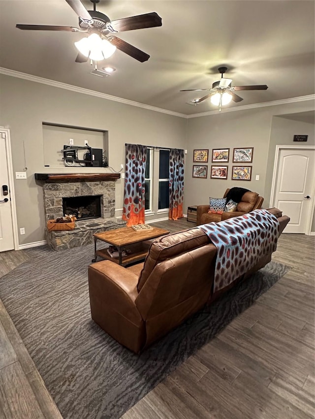 living room with crown molding, a stone fireplace, and dark wood-type flooring