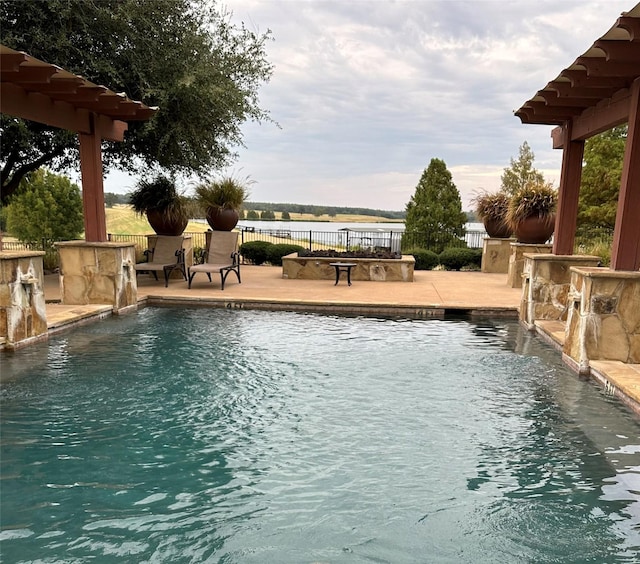 view of swimming pool featuring pool water feature and a patio