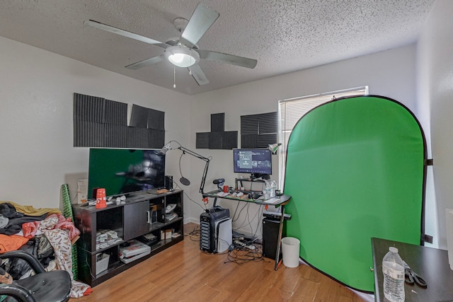 home office featuring a textured ceiling, hardwood / wood-style flooring, and ceiling fan