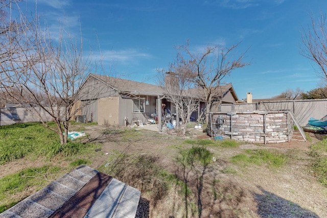 rear view of property with a patio and central AC