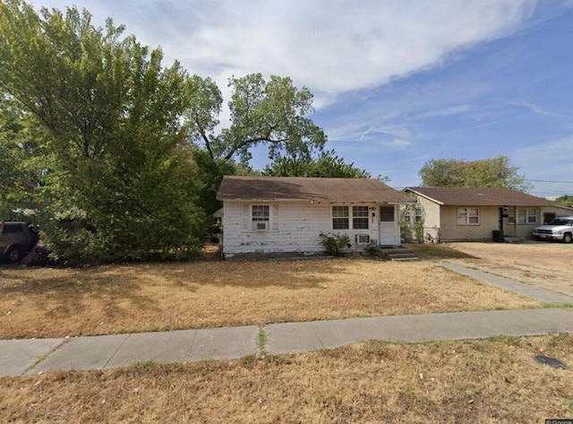 ranch-style home with a front lawn