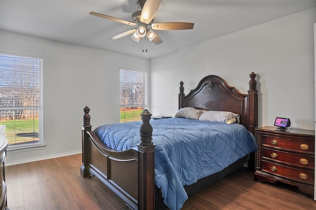 bedroom with ceiling fan and dark hardwood / wood-style flooring