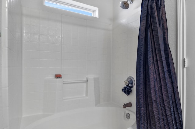 bathroom with shower / bath combo with shower curtain