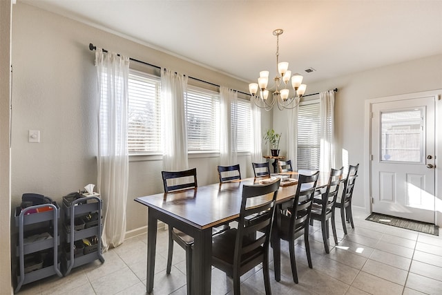 dining room with light tile patterned flooring and an inviting chandelier