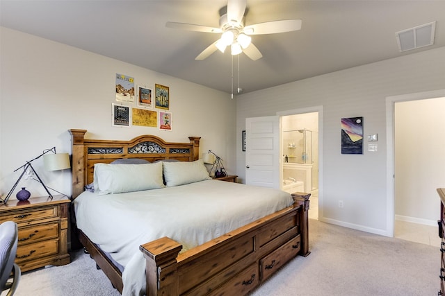 carpeted bedroom with ceiling fan and ensuite bath