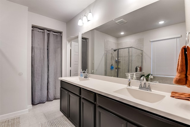 bathroom with tile patterned flooring, vanity, and an enclosed shower