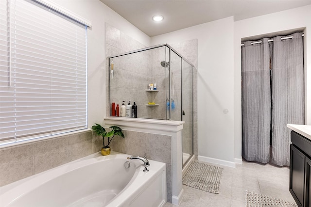 bathroom with tile patterned flooring, shower with separate bathtub, and vanity