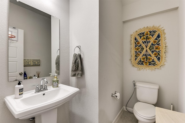 bathroom with toilet and sink