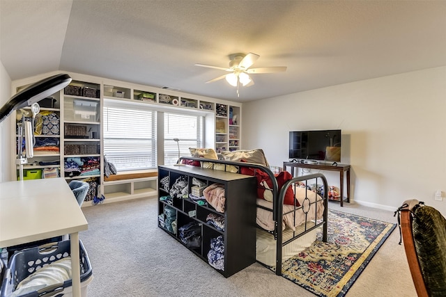 carpeted bedroom featuring vaulted ceiling, ceiling fan, and a textured ceiling