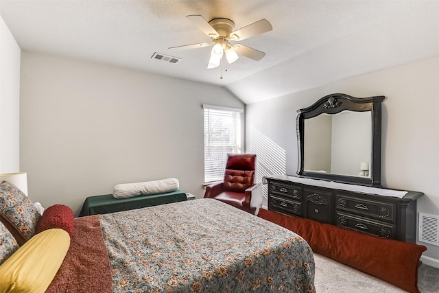 bedroom featuring a textured ceiling, ceiling fan, carpet floors, and vaulted ceiling