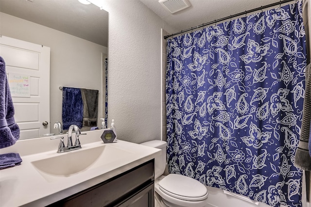 bathroom with vanity, a shower with shower curtain, a textured ceiling, and toilet