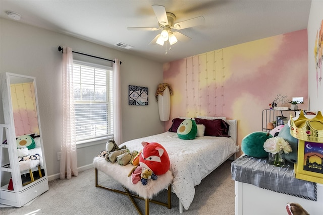 carpeted bedroom featuring multiple windows and ceiling fan