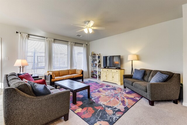 carpeted living room featuring ceiling fan