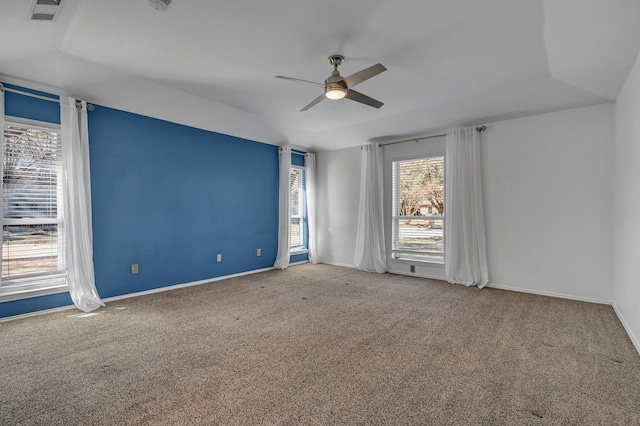 spare room featuring carpet floors, a tray ceiling, ceiling fan, and lofted ceiling