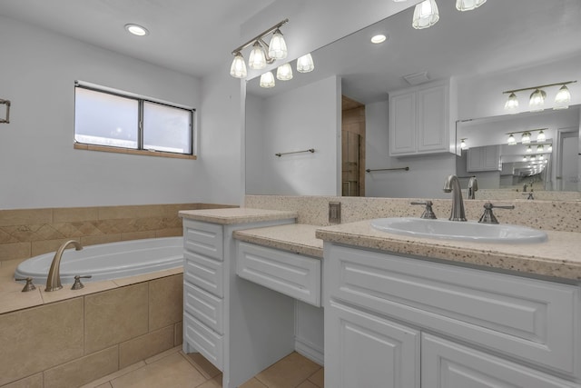 bathroom featuring tile patterned flooring, vanity, and separate shower and tub