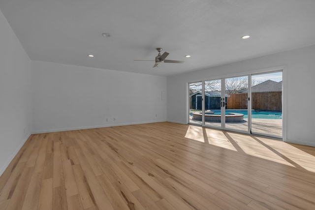 unfurnished living room with ceiling fan and light wood-type flooring