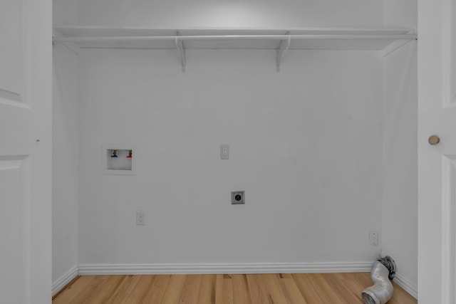 clothes washing area with hookup for an electric dryer, light hardwood / wood-style floors, and washer hookup