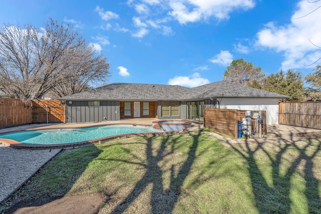 view of pool featuring a patio area, an in ground hot tub, and a yard