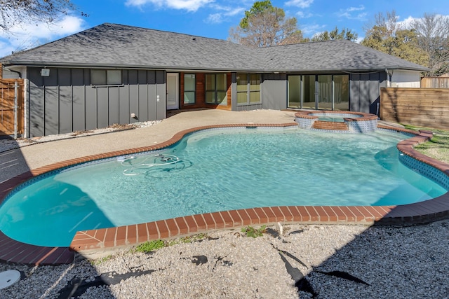 view of swimming pool with a patio area and an in ground hot tub