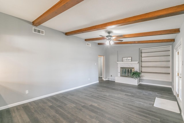 unfurnished living room with ceiling fan, dark wood-type flooring, a high end fireplace, and beamed ceiling