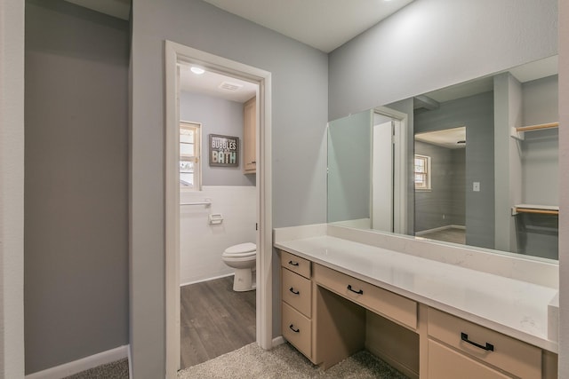 bathroom featuring hardwood / wood-style floors, vanity, tile walls, and toilet