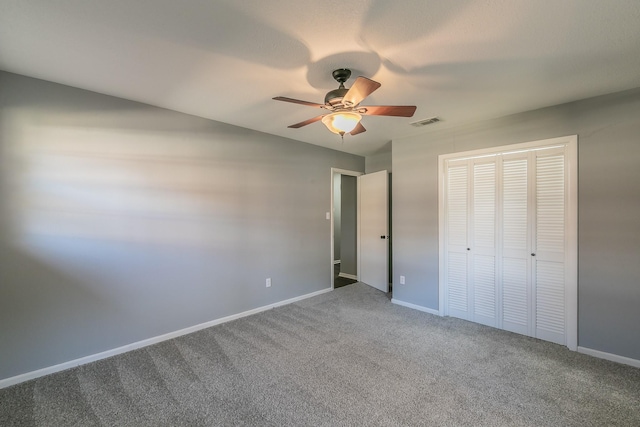 unfurnished bedroom with carpet flooring, ceiling fan, and a closet