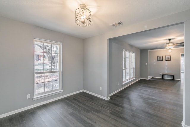 unfurnished room with dark wood-type flooring and ceiling fan