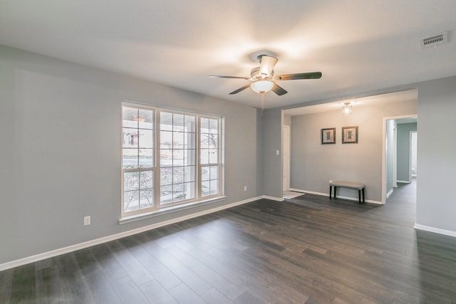 spare room featuring dark hardwood / wood-style floors and ceiling fan