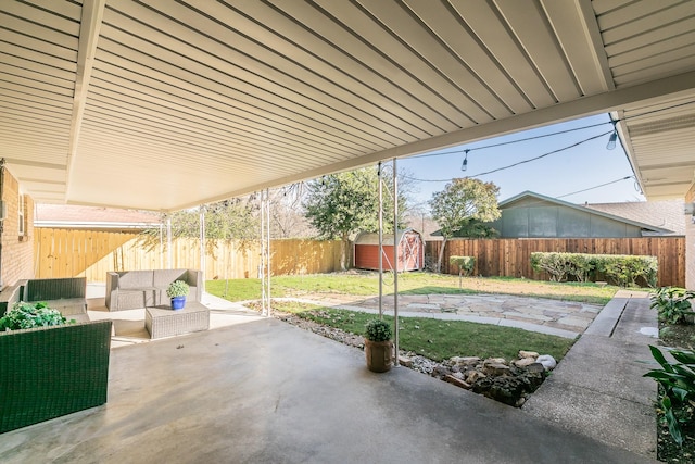 view of patio featuring a storage shed and an outdoor living space