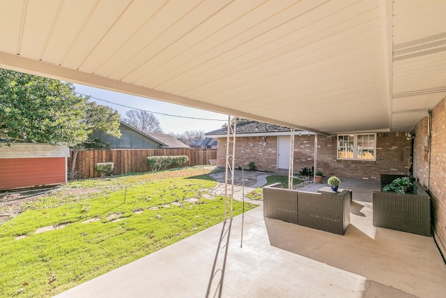 view of patio / terrace featuring outdoor lounge area and a storage unit