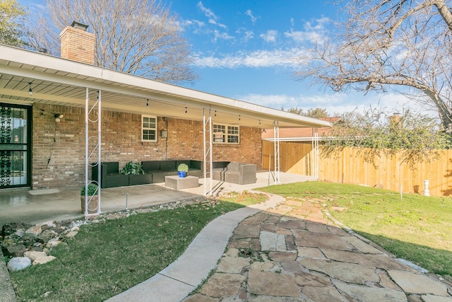 back of property featuring an outdoor living space, a lawn, and a patio