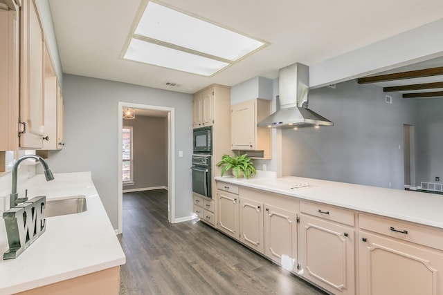 kitchen featuring sink, beam ceiling, black appliances, dark hardwood / wood-style flooring, and wall chimney exhaust hood