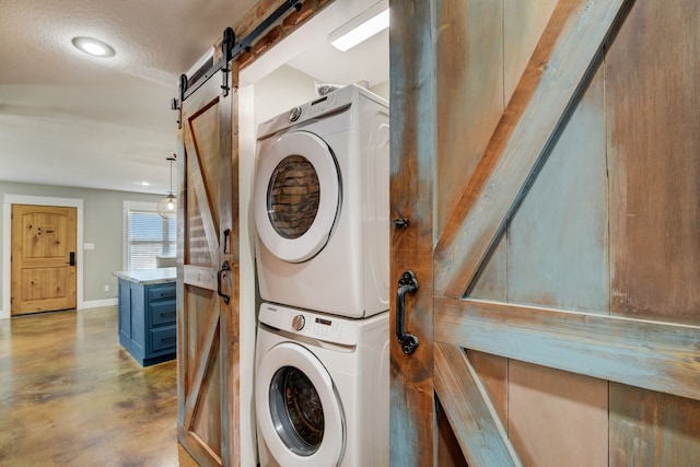 405 Hubbard, Josephine, TX 75173 - laundry room with a barn door and stacked washer and clothes dryer