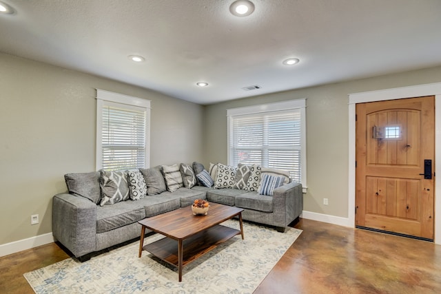 living room featuring plenty of natural light and a textured ceiling