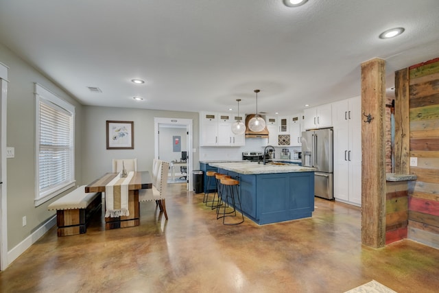 405 Hubbard, Josephine, TX 75173 - kitchen featuring white cabinetry, high quality fridge, decorative light fixtures, and a center island with sink