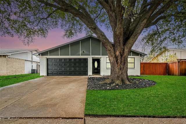 view of front facade with a garage and a yard