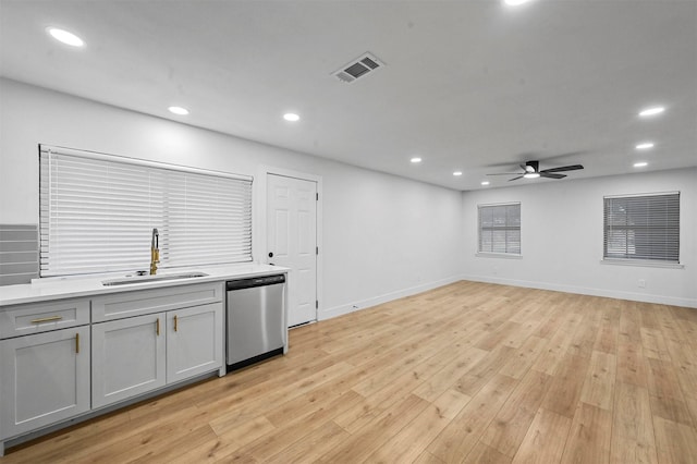 kitchen featuring ceiling fan, dishwasher, sink, light hardwood / wood-style floors, and gray cabinets