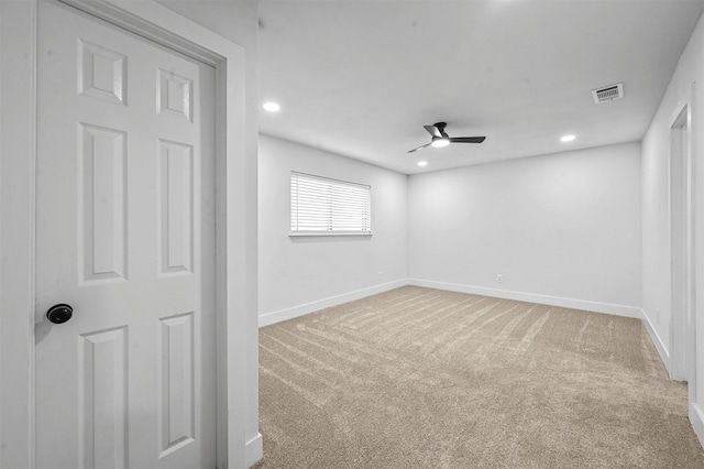 spare room featuring carpet flooring and ceiling fan