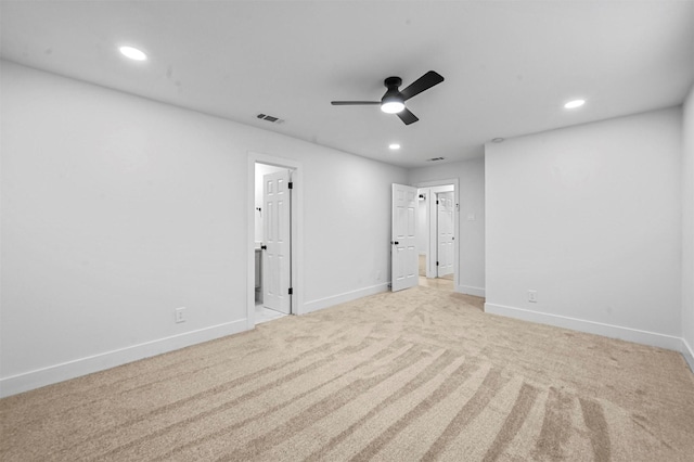 carpeted spare room featuring ceiling fan