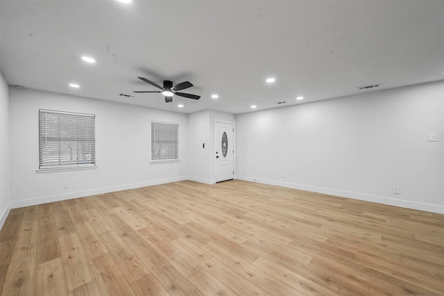 unfurnished room with ceiling fan and light wood-type flooring