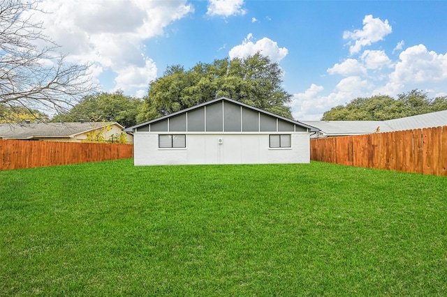 rear view of property featuring a lawn