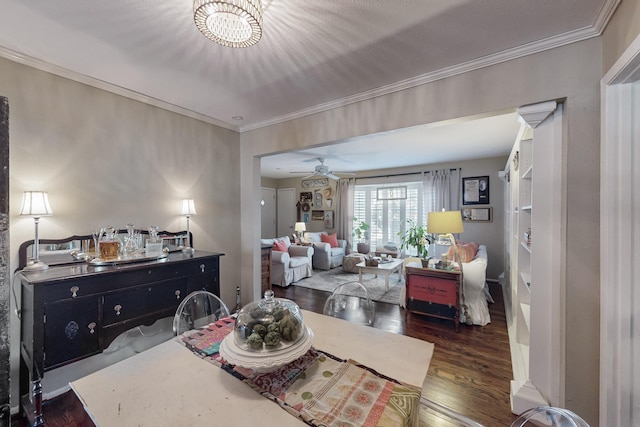 bedroom with a notable chandelier, dark hardwood / wood-style floors, and ornamental molding