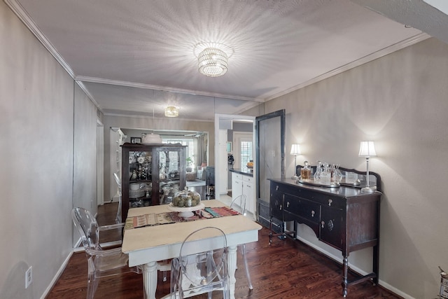 dining space featuring baseboards, wood finished floors, and crown molding