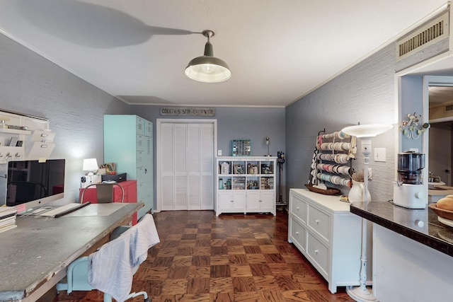 interior space featuring dark parquet flooring, white cabinets, and decorative light fixtures